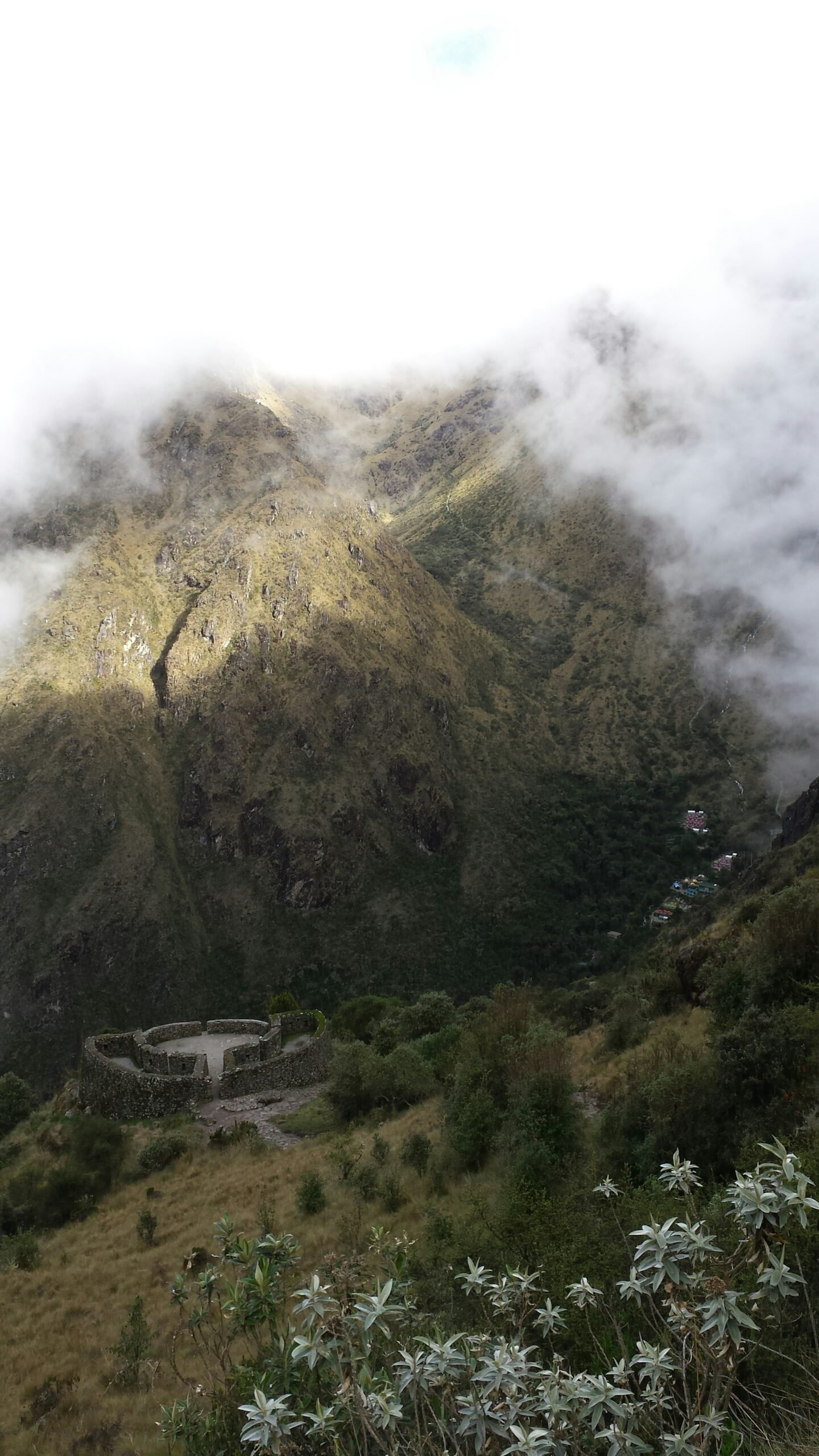 Vista aérea de ruinas incas con montañas andinas envueltas en niebla